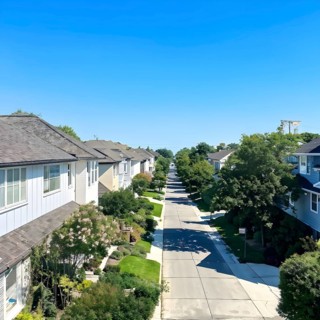 A serene suburban street with blooming plants under a bright sky, AI generated