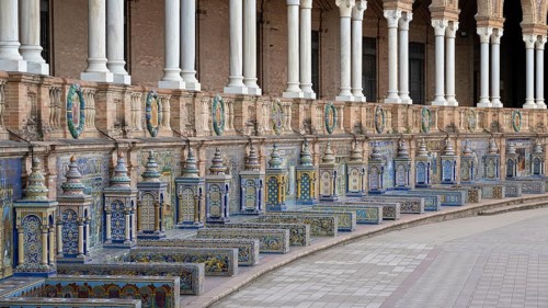Colourful azulejos, colonnade and tiled benches of the pavilion at the Plaza de Espana in Seville,