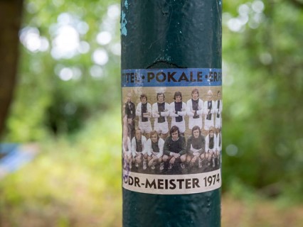 Sticker with the photo of the football team 1. FC Magdeburg, GDR champion 1974, on a lamppost at