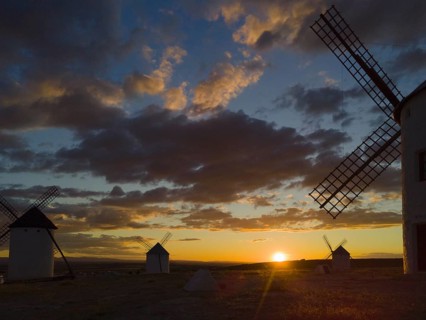 Sunset with silhouettes of windmills against a colourful sky with dramatic clouds, windmills, Campo