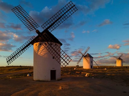 Several windmills at sunset in an open landscape under a cloudy sky, windmills, Campo de Criptana,