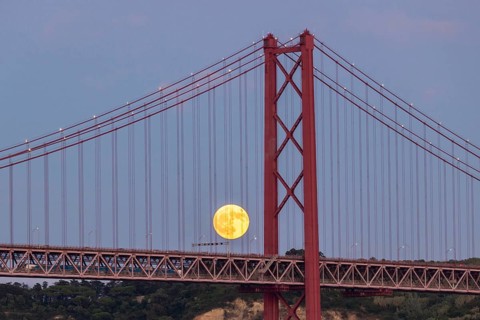 Full Moon and 25th of April Bridge. Lisbon, Portugal, Europe