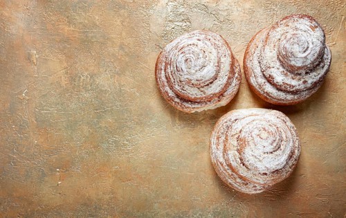 Bakery product, lemon twist, with white glaze, sweet bun, muffin, pastries, top view, no people