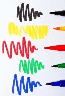Watercolor pens brush, assortment, on a drawing album, artist's desk, top view, close-up, selective