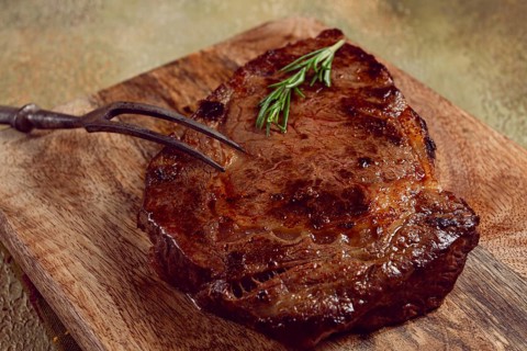 Grilled steak, beef steak, rib eye steak, on a chopping board, top view, no people