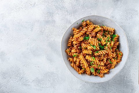 Pasta in navy, pasta with minced meat, gray background, homemade, fusilli pasta, no people