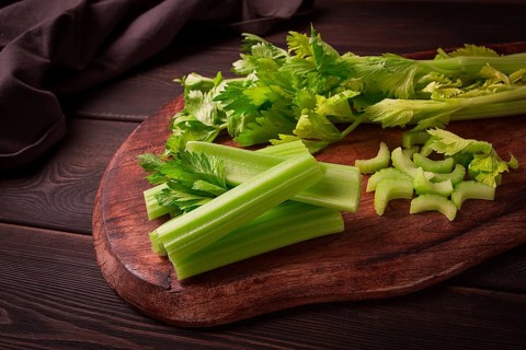 Fresh bunch of celery, top view, no people, on a dark background