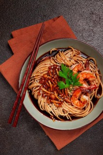 Soba, buckwheat noodles, with shimeji mushrooms and tiger shrimps, sesame, lime, parsley, homemade,