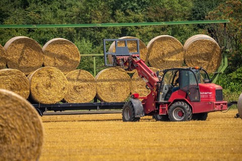 Straw bales, round bales, are loaded onto a trailer after the grain harvest, near Neuss North