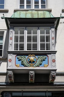 Artfully decorated bay window, stonemasonry work on a historic town house in the monastery quarter,