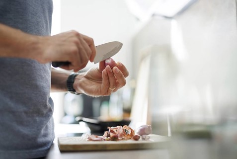 Cooking topic. A man peels an onion. Berlin, 01.08.2024