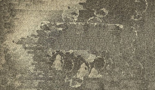 Abstract monochrome art with rough texture and circular patterns creating a distressed feel