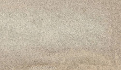 Beige plastered wall with rough texture creating a neutral background