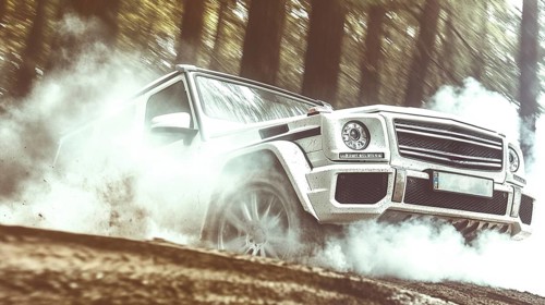 White SUV drifting through a dusty forest path with dramatic sunlight filtering through the trees,