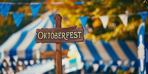 Banner with wooden sign with text 'Oktoberfest' at traditional Bavarian German festival. Generative