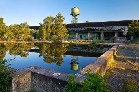 The water tower with the Jahrhunderthalle in Westpark, industrial heritage, Bochum, Ruhr area,