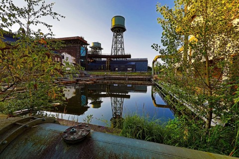 The water tower is reflected in the water basins at the Jahrhunderthalle in Westpark, Industrial