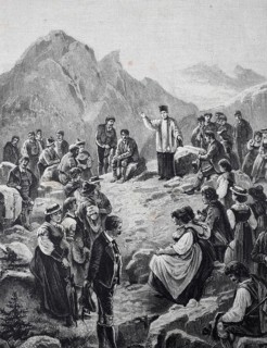 Mountain sermon in the Tyrolean Alps, People in traditional dress gather in the mountains while a