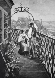 Couple standing on a balcony of the tower guard. A view of the city can be seen in the background,