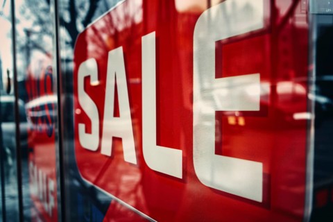 Red sale sign with text 'Sale' in shopping window. Generative AI, AI generated