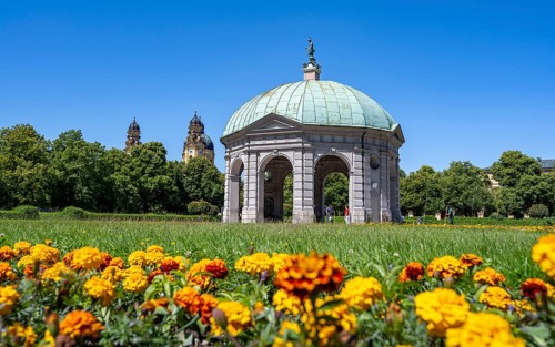 Diana Temple in the Hofgarten with yellow flowers and Theatine Church, Old Town, Munich, Upper