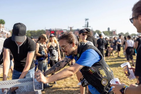 Festival visitors refresh themselves at the Wacken Open Air in Wacken. The traditional metal