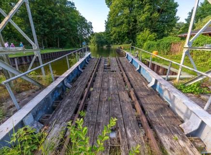 Landing stage of the historic railway ferry with overgrown old rails on the banks of the Havel in