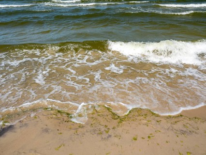 Water flowing onto the sandy beach on the island of Usedom on the Baltic Sea, Zempin,