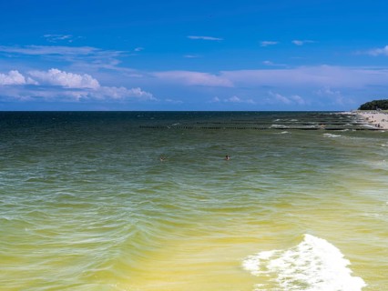 Sandy beach beach with clouds in the blue sky on the island of Usedom on the Baltic Sea, Zempin,