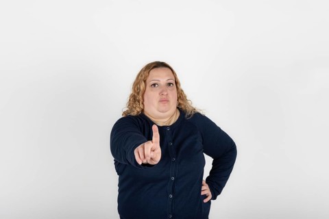 Plus size woman making an objection with her hand