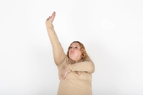 Plus size woman doing a Breast Self-Exam (BSE)