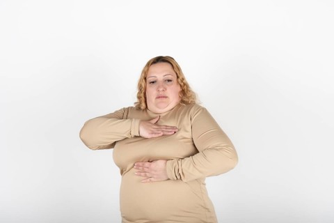 Plus size woman doing a Breast Self-Exam (BSE)