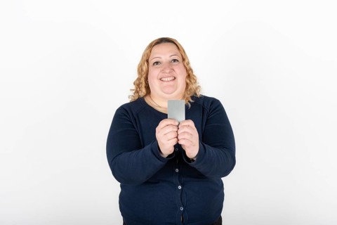 Woman smiling happily showing her credit card