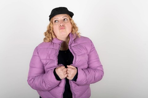 Plus size woman wearing purple jacket and black beret