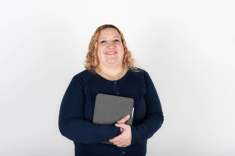 Portrait of blonde plus size woman looking at camera smiling