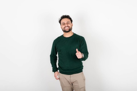 Man looking at camera smiling with thumb up
