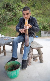 Vietnamese man smoking a thick bamboo pipe, Ha Giang province, Vietnam, Asia