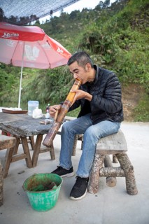 Vietnamese man smoking a thick bamboo pipe, Ha Giang province, Vietnam, Asia