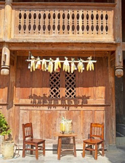 Corn on the corn cob hanging from a traditional house, Pa Vi Hmong Cultural Village, Meo Vac, Ha