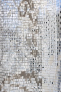 Vertical close-up image of a white translucent curtain with embroidery details, AI generated