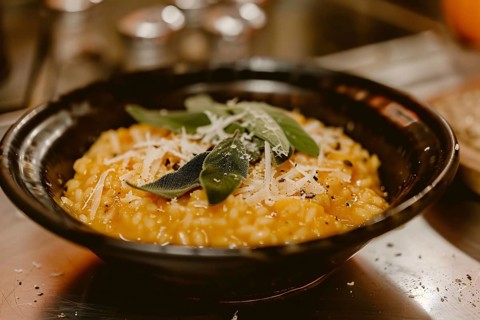 Creamy pumpkin risotto with sage and Parmesan cheese. Generative Ai, AI generated