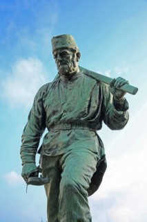 Miner Henner with pickaxe by Friedrich Reusch 1902, symbol for miner in mining, mine, worker,