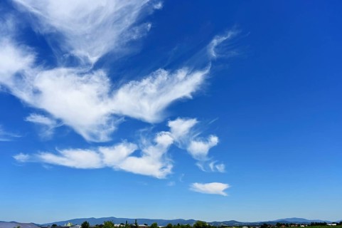 Cirrus or cirrus clouds in the blue sky over the mountains of the Bavarian Forest, Plattling, Lower