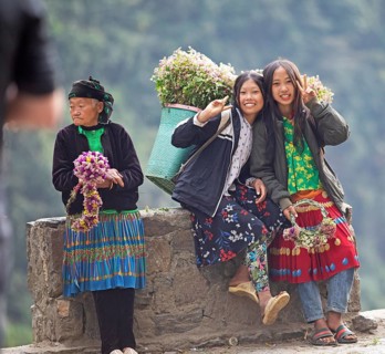 Vietnamese woman selling flowers in the northern mountains, Ha Giang province, Vietnam, Asia