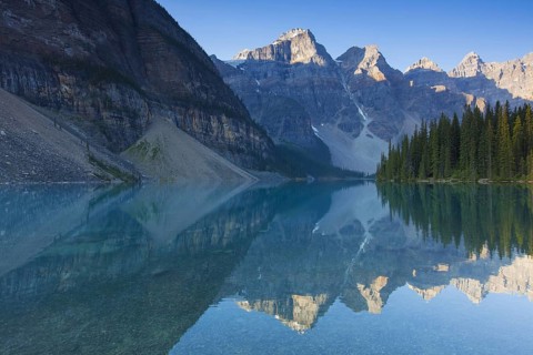 Mountains reflected in glacial water of Moraine Lake in the Valley of the Ten Peaks, Banff National