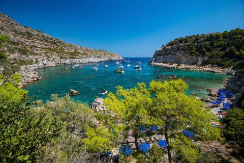 Beach umbrellas and sunbeds, turquoise waters, Anthony Quinn Bay, Faliraki, Rhodes, Dodecanese,