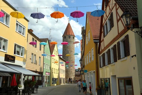 FÃ¤rberturm also called Pulverturm, coloured umbrellas in the sky, Gunzenhausen, Altmühltal,