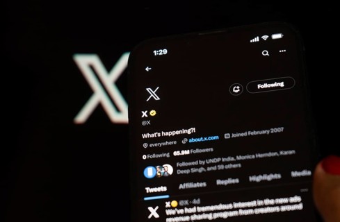 In this photo illustration a person browsing Elon musk X account, formerly Twitter, on an iPhone,