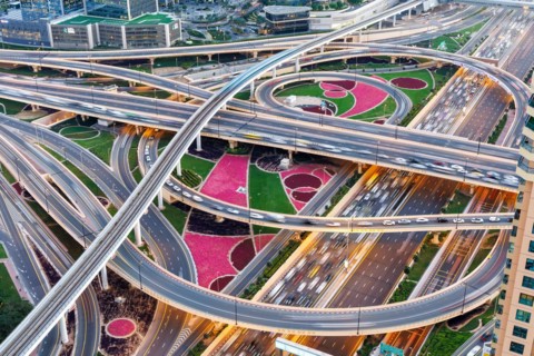 Intersection of Sheikh Zayed Road traffic on the road near the Burj Khalifa with Metro in Dubai,