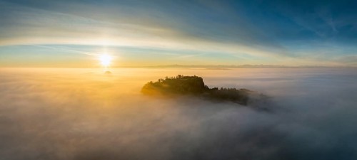 Aerial view of the Hegau volcano Hohentwiel with the upper fortress ruins as a silhouette at